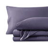 A sateen sheet set folded and stacked on a white background.