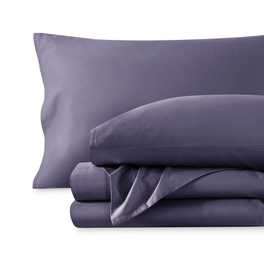 A sateen sheet set folded and stacked on a white background.