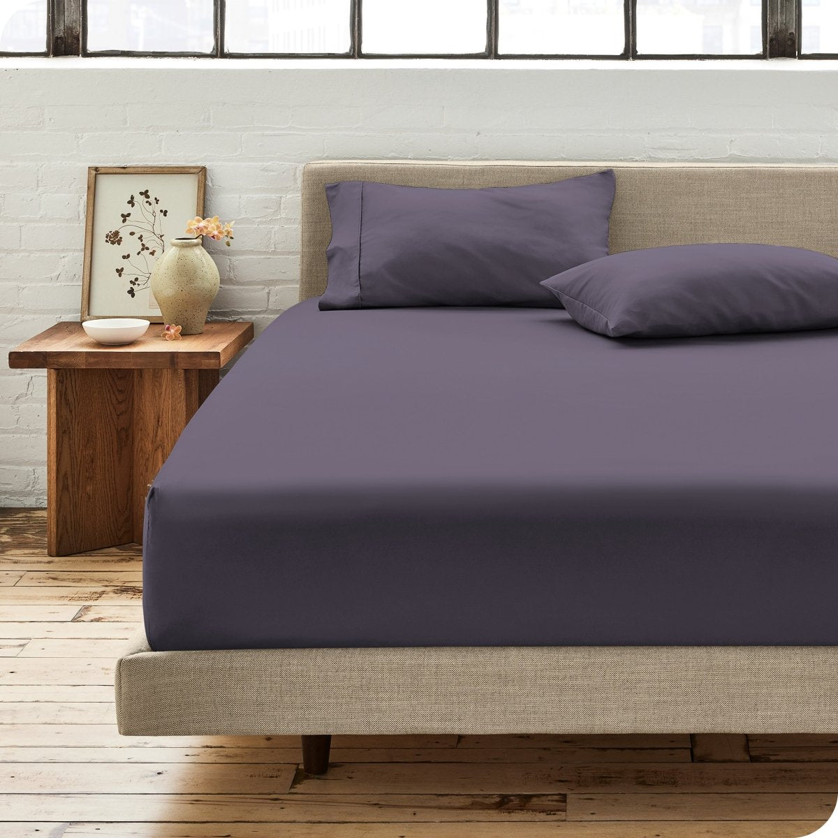 Modern bedroom with bed showing percale fitted sheet