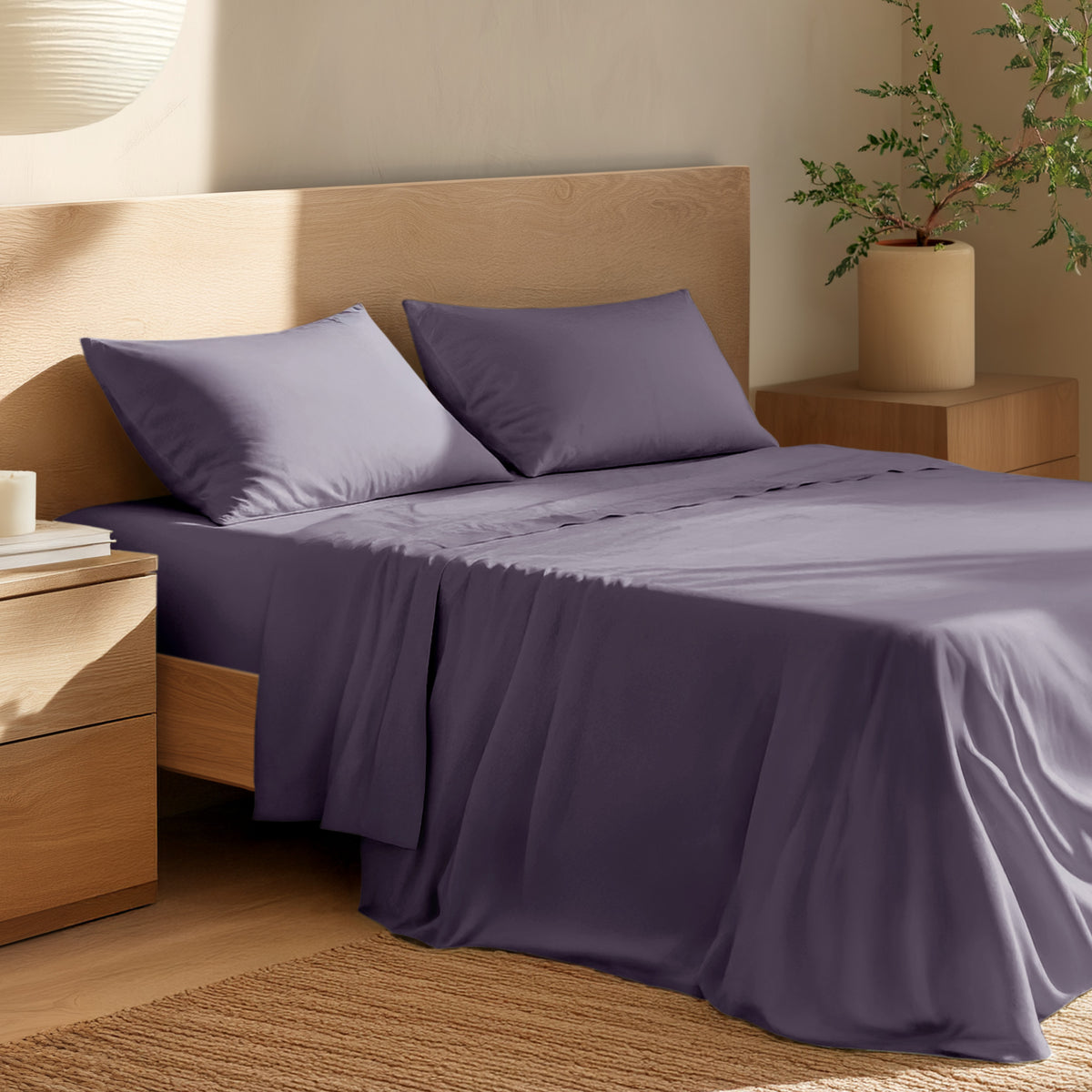 Bed with percale bedding and wooden headboard in a bedroom setting