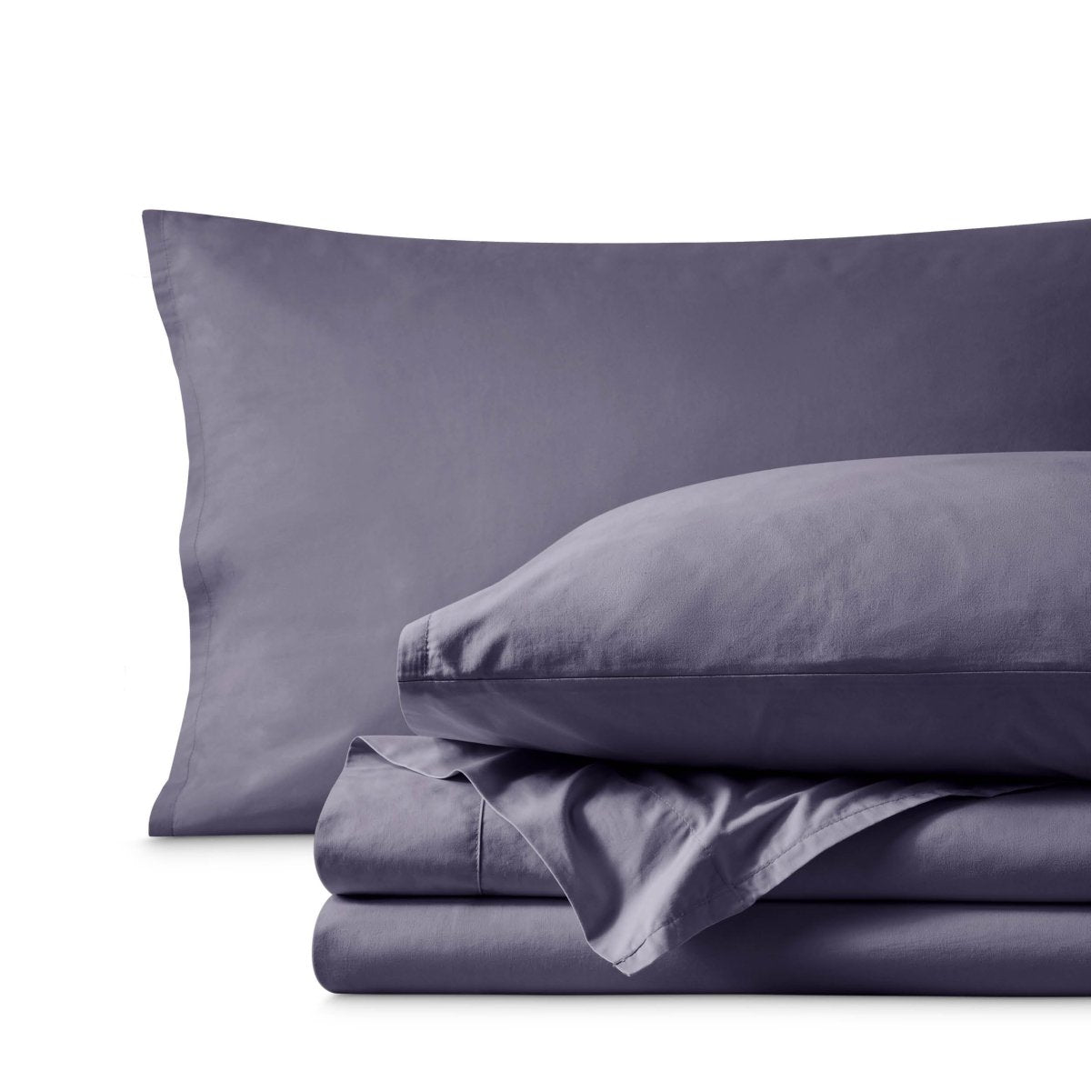 Percale bedding set including pillowcases and folded sheets arranged on a clean white background