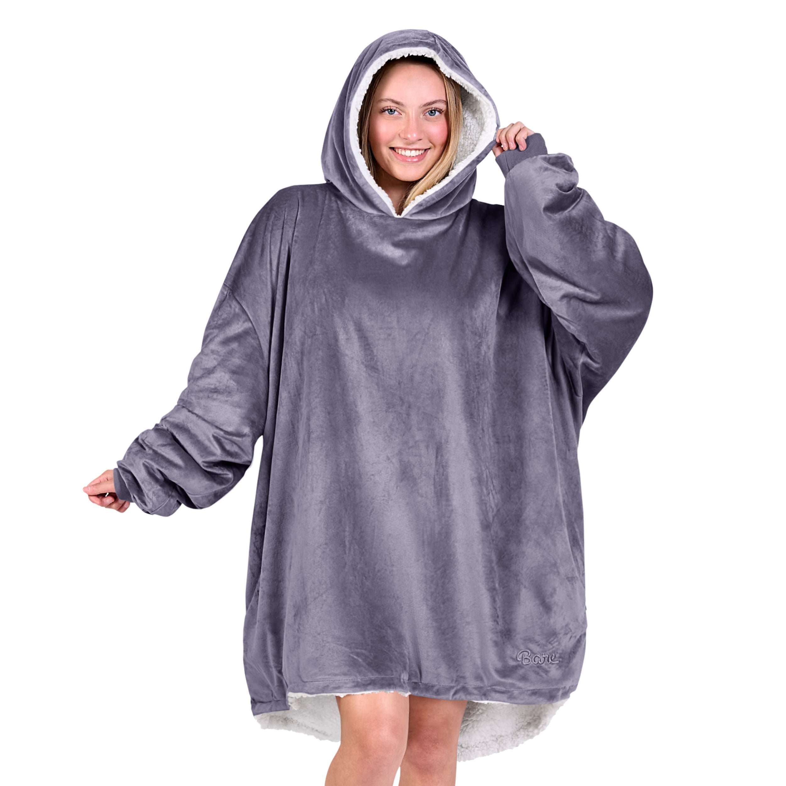 An adult with a sherpa wearable blanket on