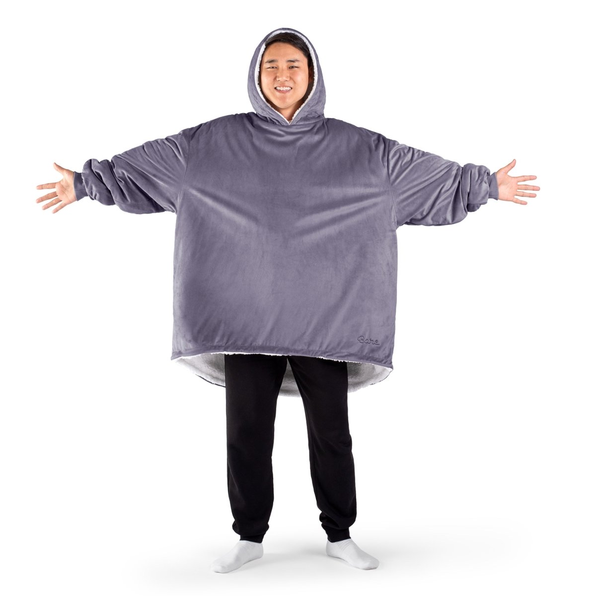 An adult with a sherpa wearable blanket on