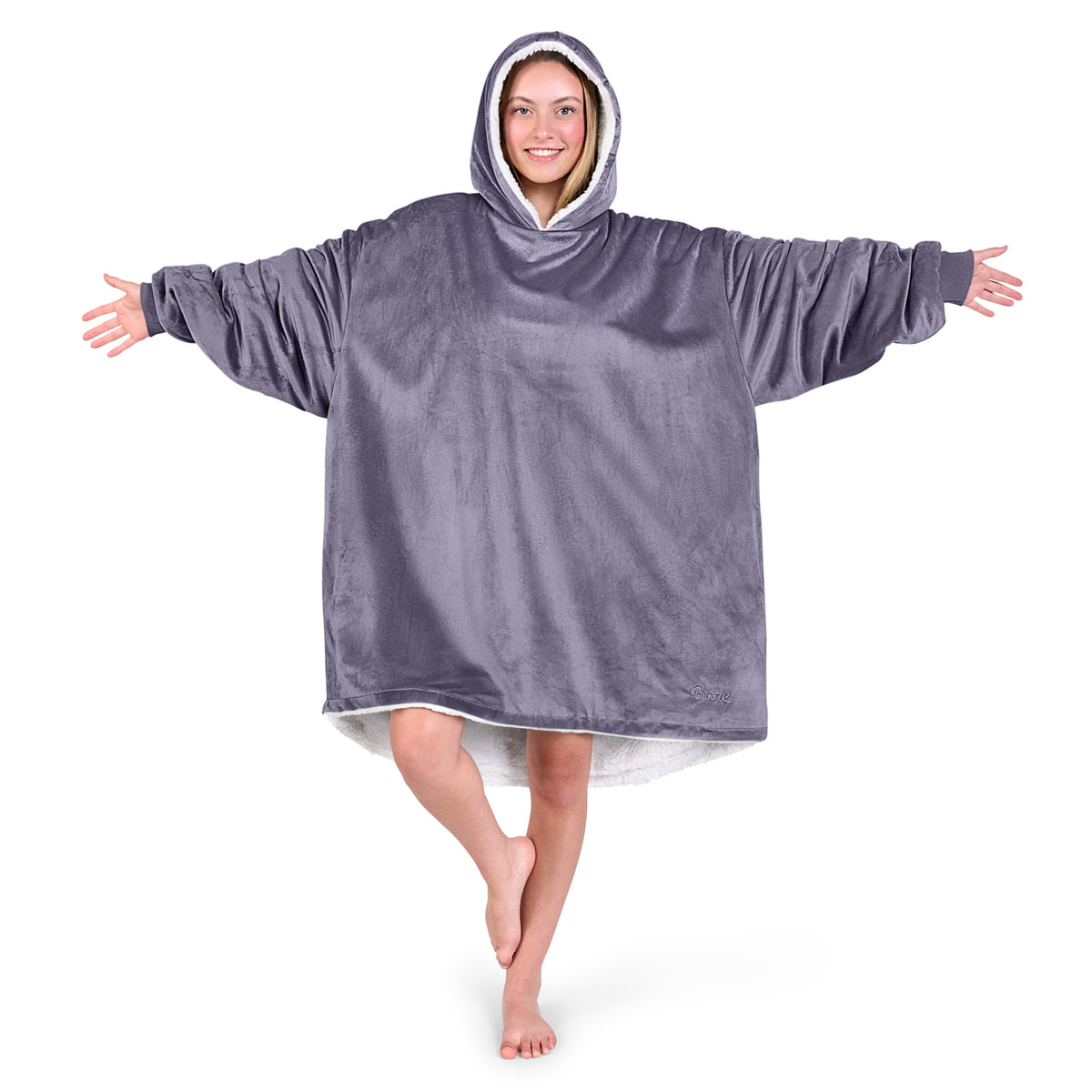 An adult with a sherpa wearable blanket on
