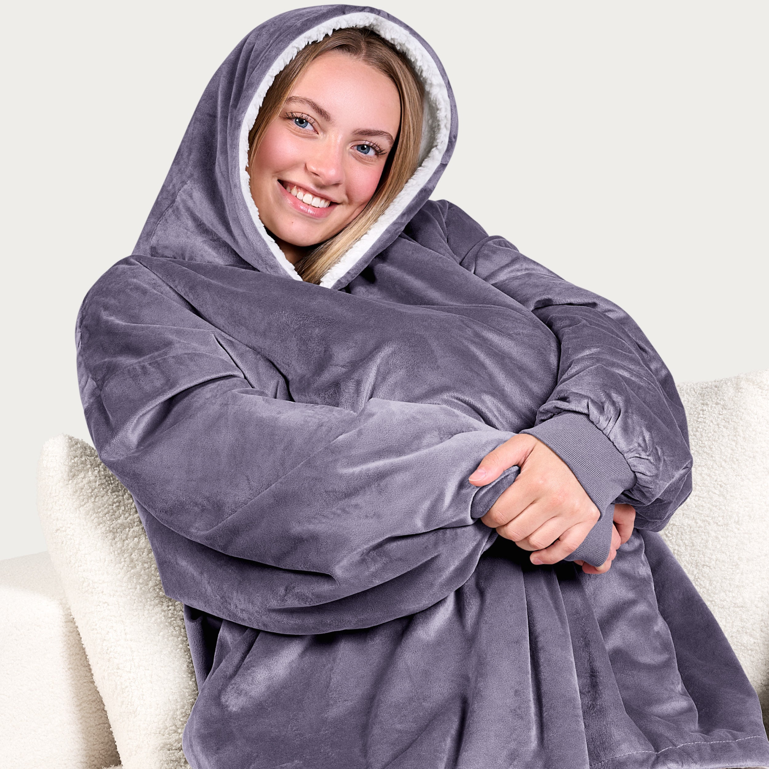 An adult with a sherpa wearable blanket on