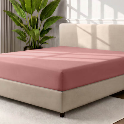 Ultra soft fitted sheet on a mattress with the sun shining into the bedroom