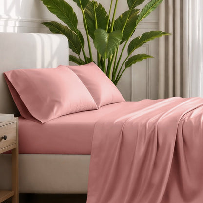 Ultra-soft sheets and pillowcases on a bed with a plant in the background