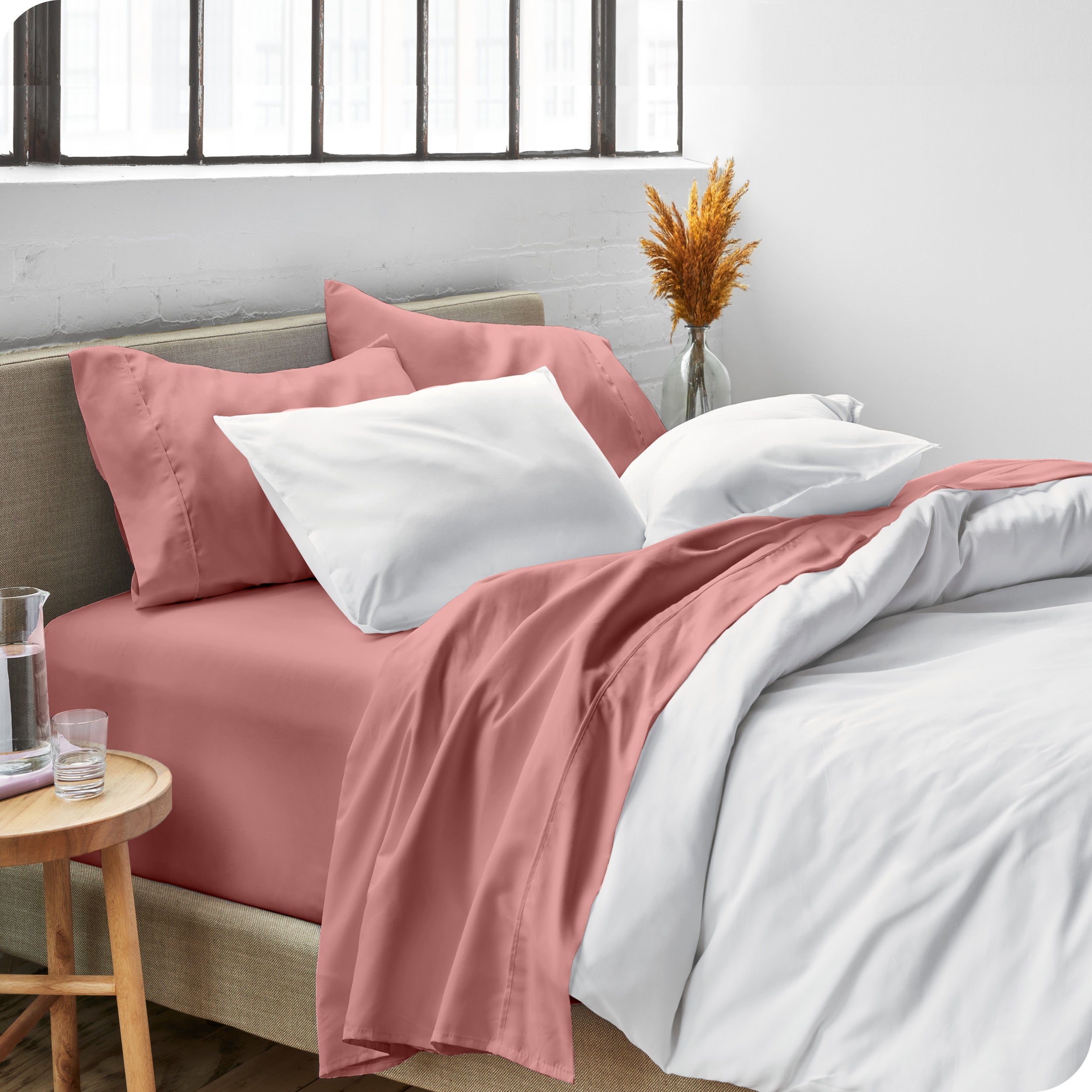 Sheets and a duvet cover on a bed in a bright bedroom