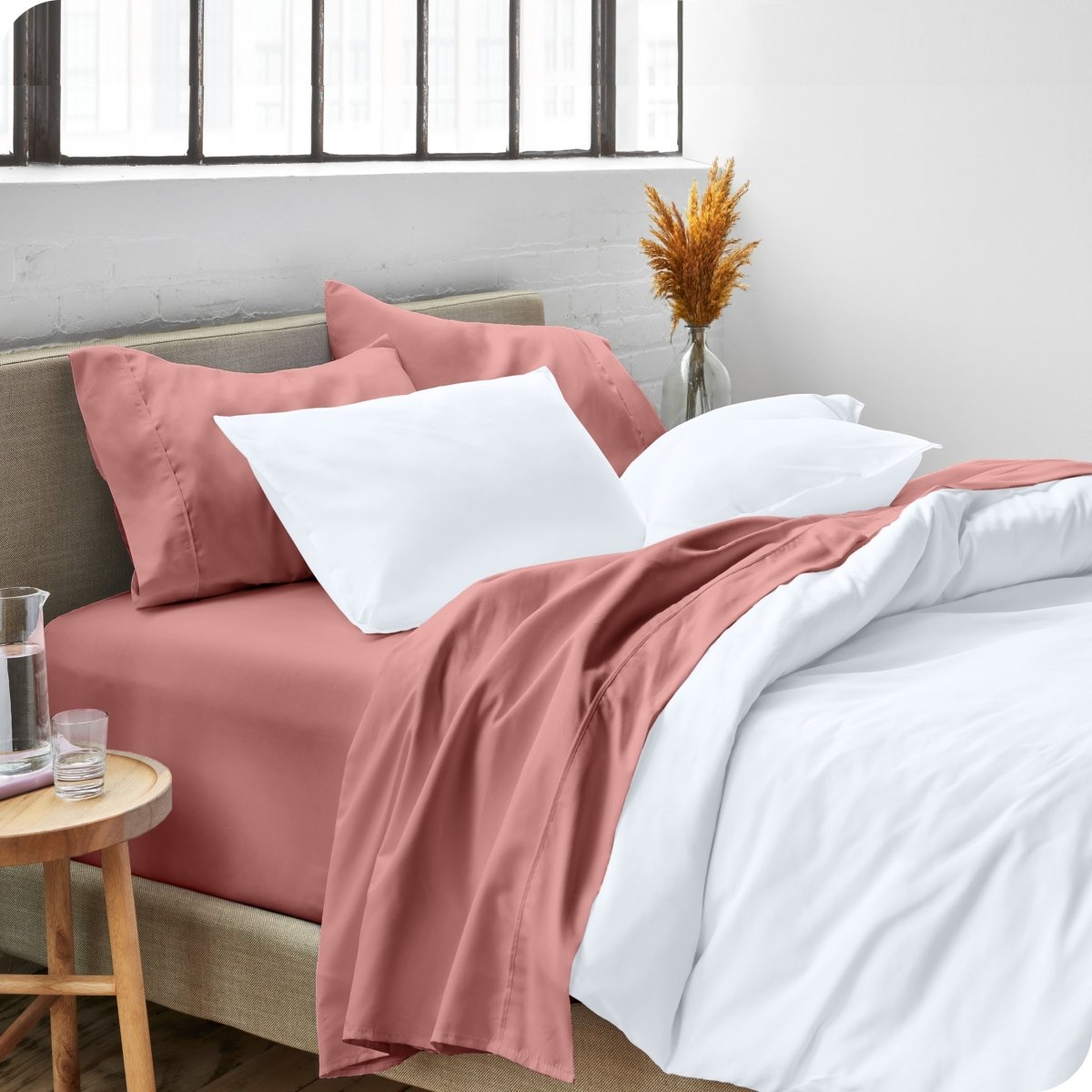 A side view of a bed made with microfiber sheets and a white duvet cover