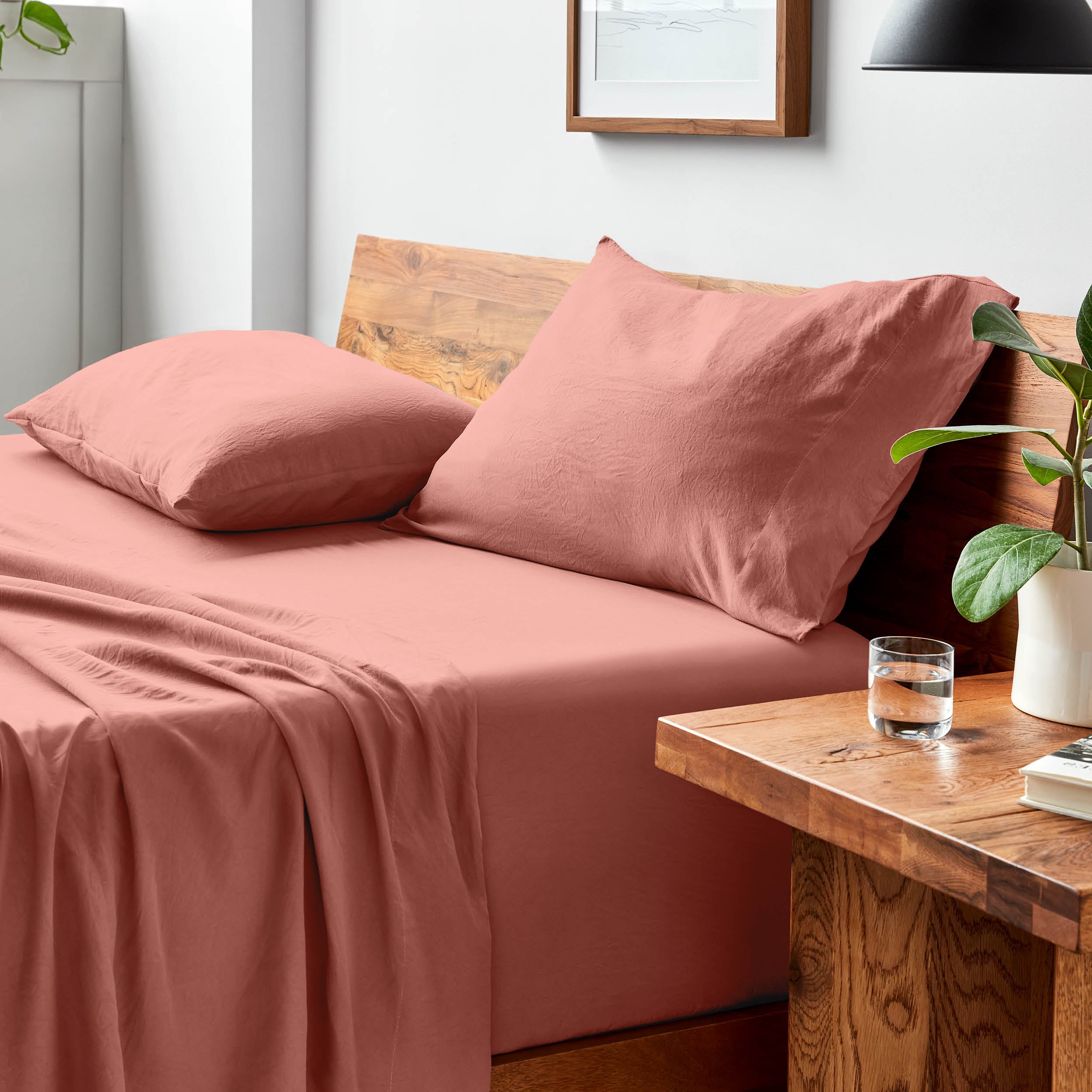 Bed with microfiber bedding and pillows in a bedroom setting