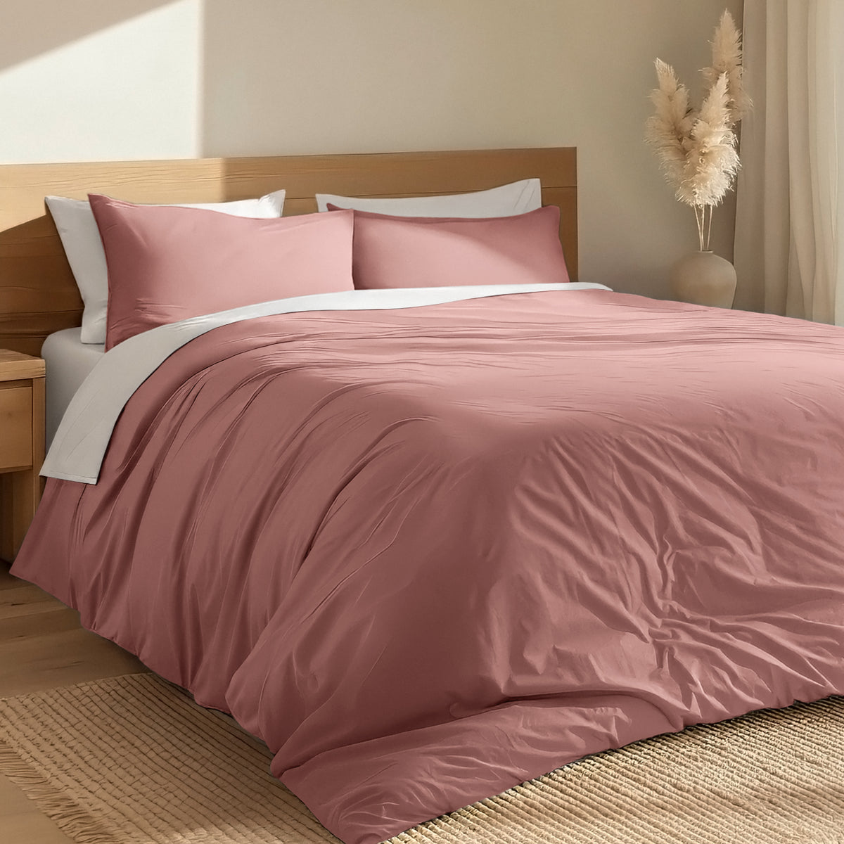 Bed with percale duvet cover set and wooden headboard in a room with a vase and decorative items.