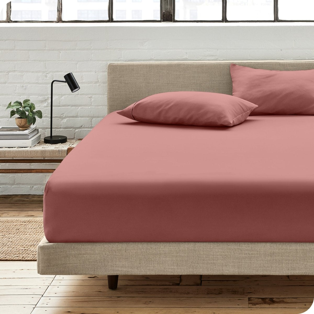 Bedroom scene with organic cotton fitted sheet and pillowcases on a bed
