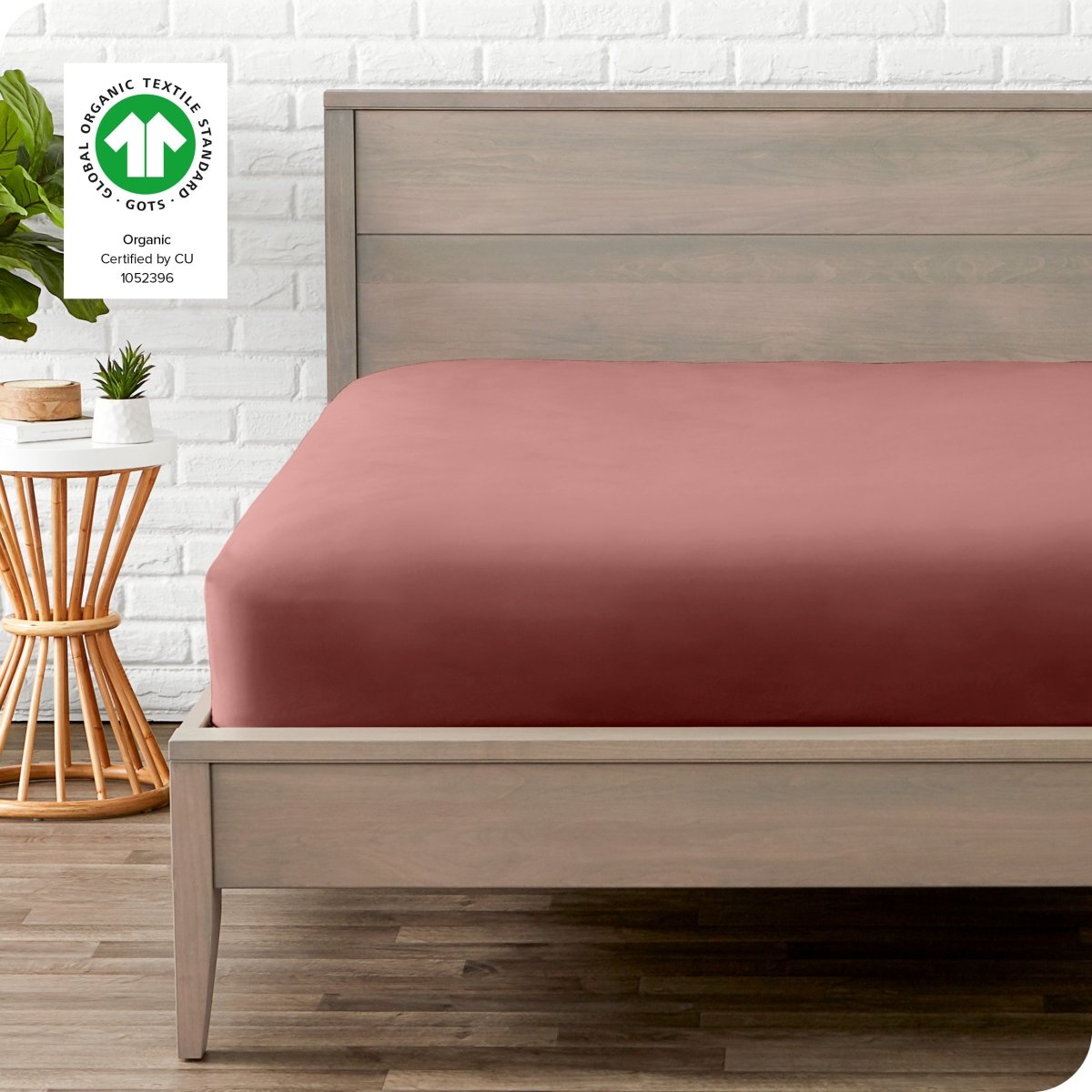 Modern wood bed frame with a sateen fitted sheet on the mattress