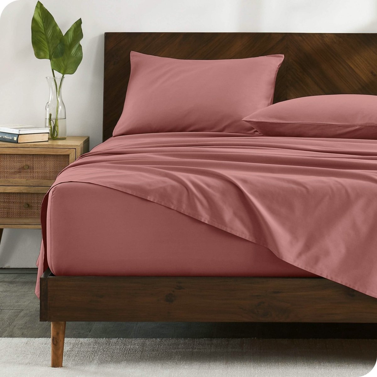 A bed made with organic cotton sateen sheets