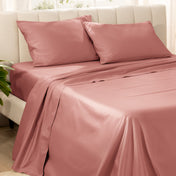 Bedding set on a bed with pillows in a bright room.