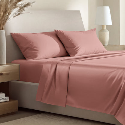 Sateen bedding set including a fitted sheet and two matching pillowcases on a bed.