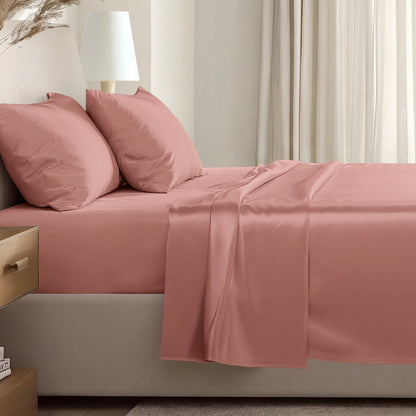 Sateen sheet set on a bed in a softly lit bedroom.