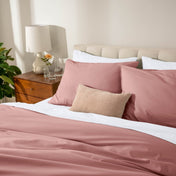 Bed with percale bedding in a bedroom setting