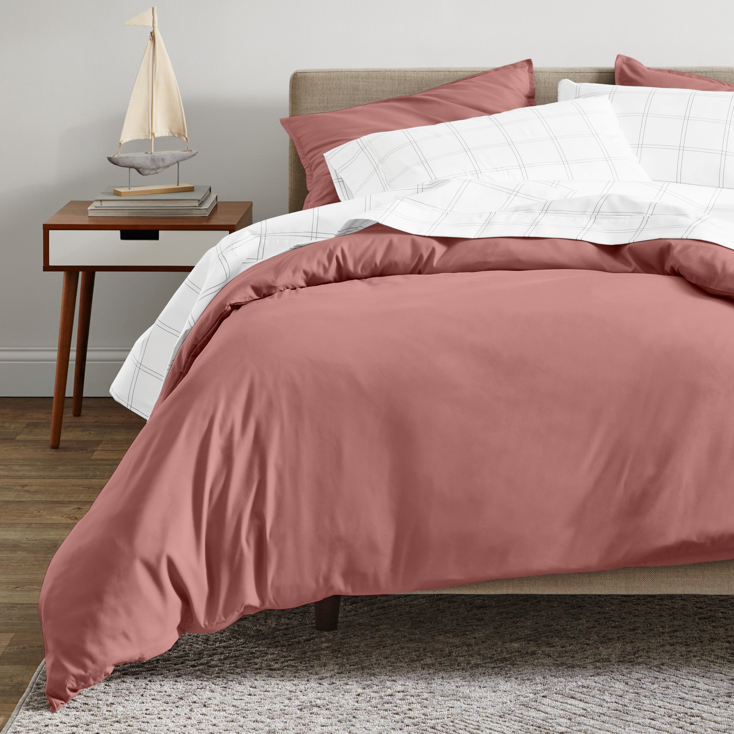 A modern bed with an organic sateen duvet cover set on.