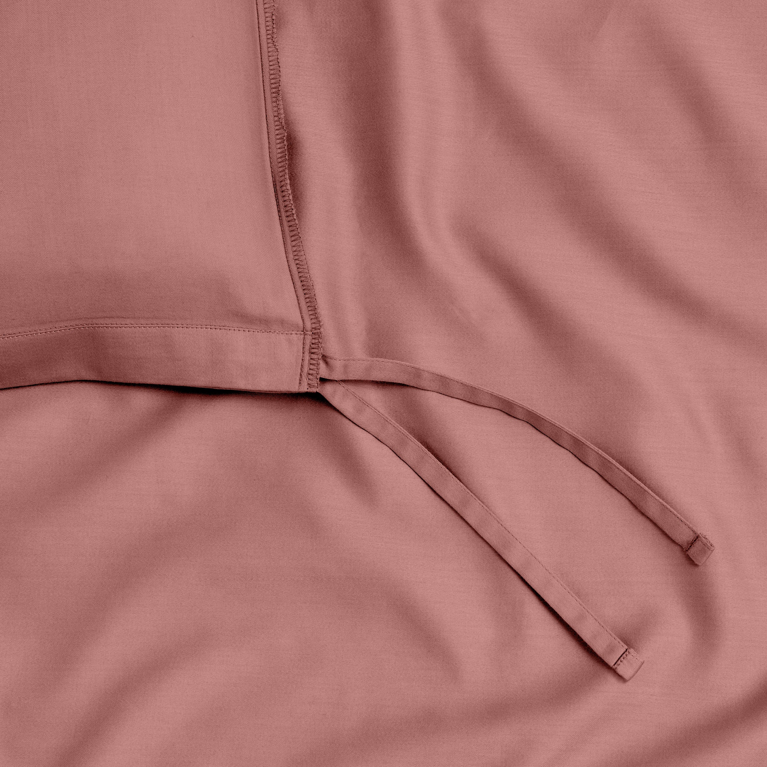 A close view of the tie corner and texture of the duvet cover.