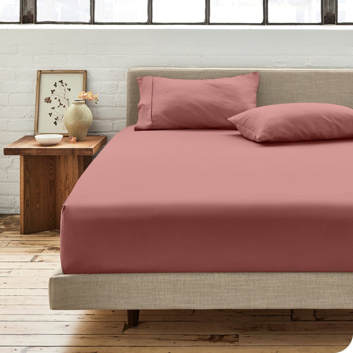 Modern bedroom with bed showing percale fitted sheet
