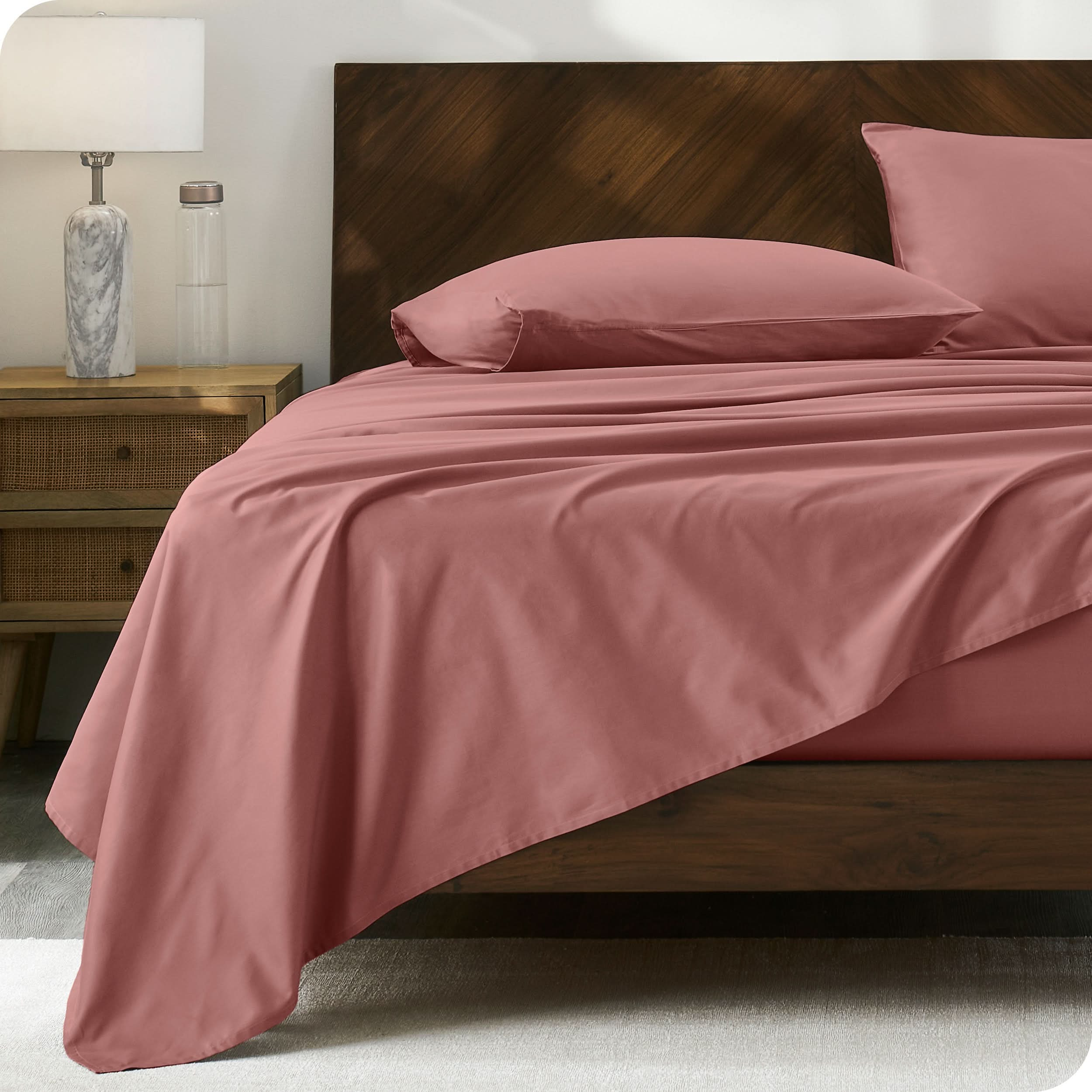 Modern wood bed with percale sheets and pillowcases