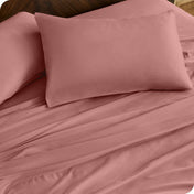 Close up of percale pillowcases and sheets on a bed