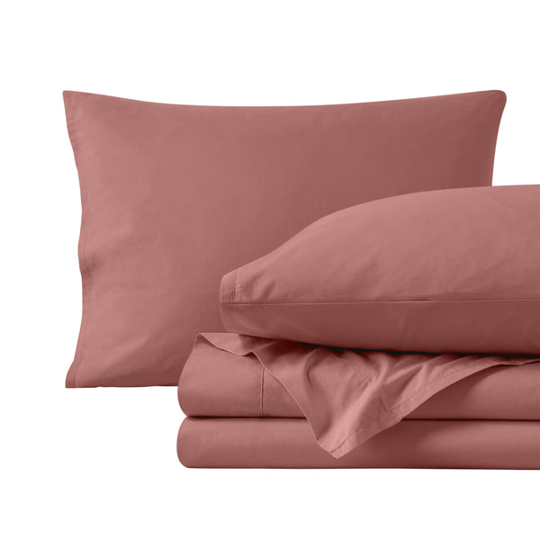 Percale sheets folded and matching pillowcases with pillows in them