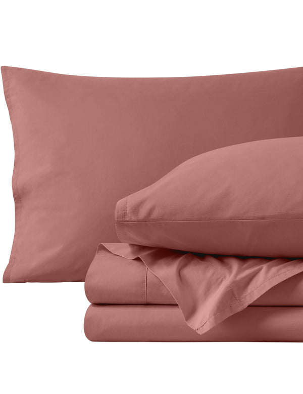 Percale sheets folded and matching pillowcases with pillows in them