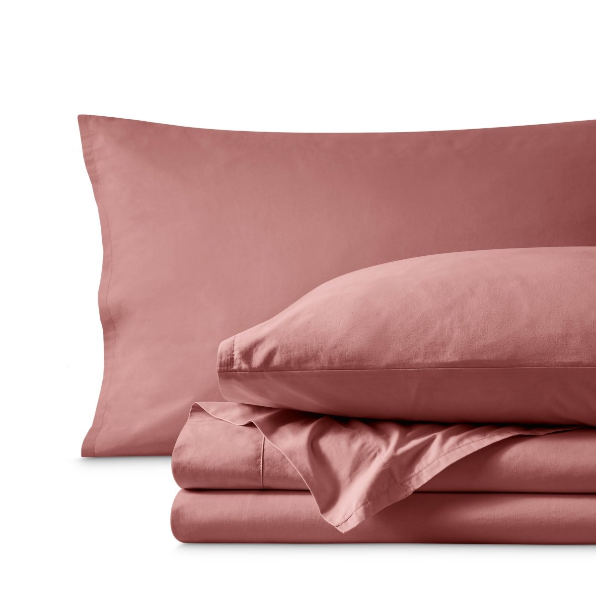 Percale bedding set including pillowcases and folded sheets arranged on a clean white background