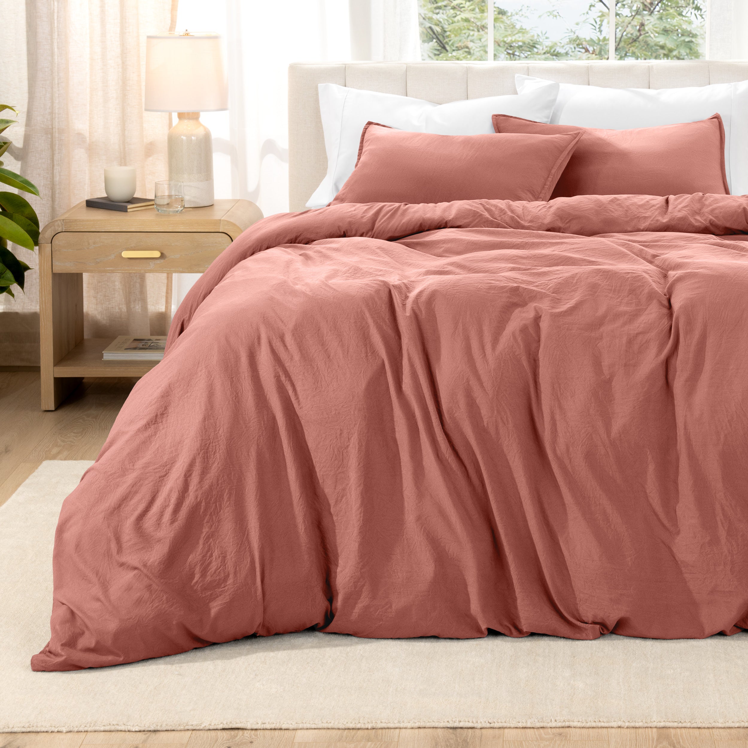 Washed bedding set on a bed with a nightstand in the background