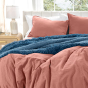 Washed duvet cover set on a bed with pillows and a lamp in the background