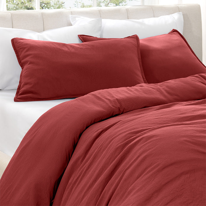 Red duvet set on a bed with white pillows