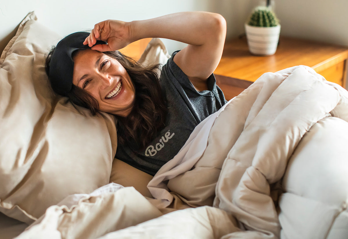 Woman smiling in Bare Home bedding