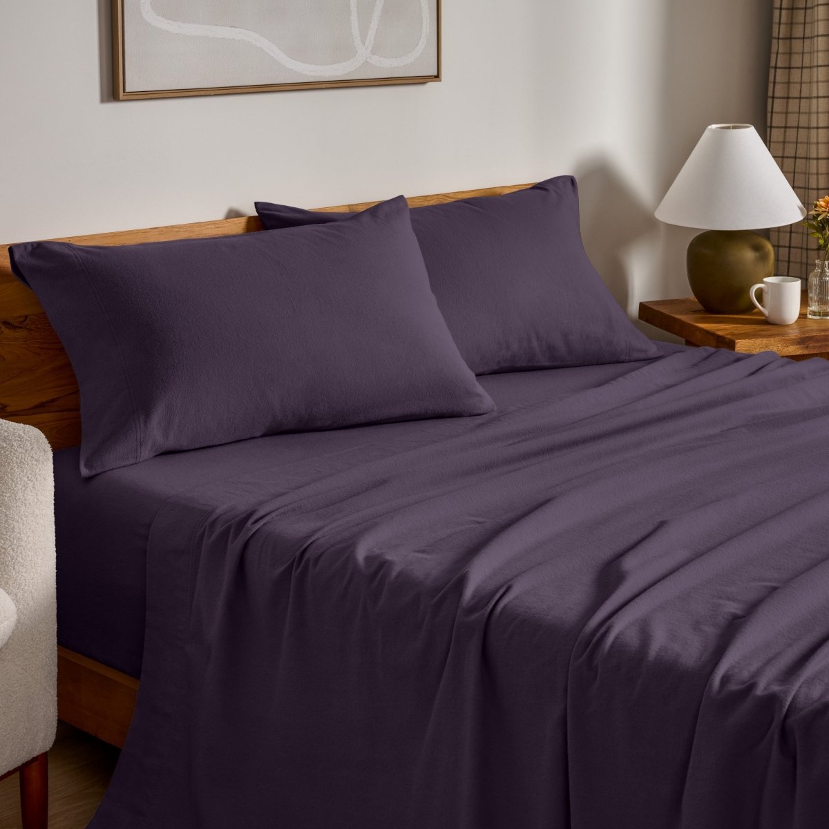 Flannel bed sheets and pillowcases on a bed in a bedroom setting.