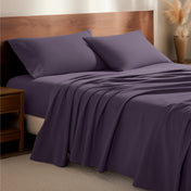 Flannel bedding set on a bed with a wooden headboard and side table
