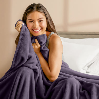 A woman cuddling with a microplush blanket