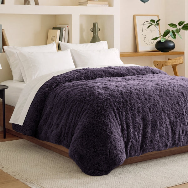 Shaggy duvet cover on a bed in a bedroom setting with shelves and decor.