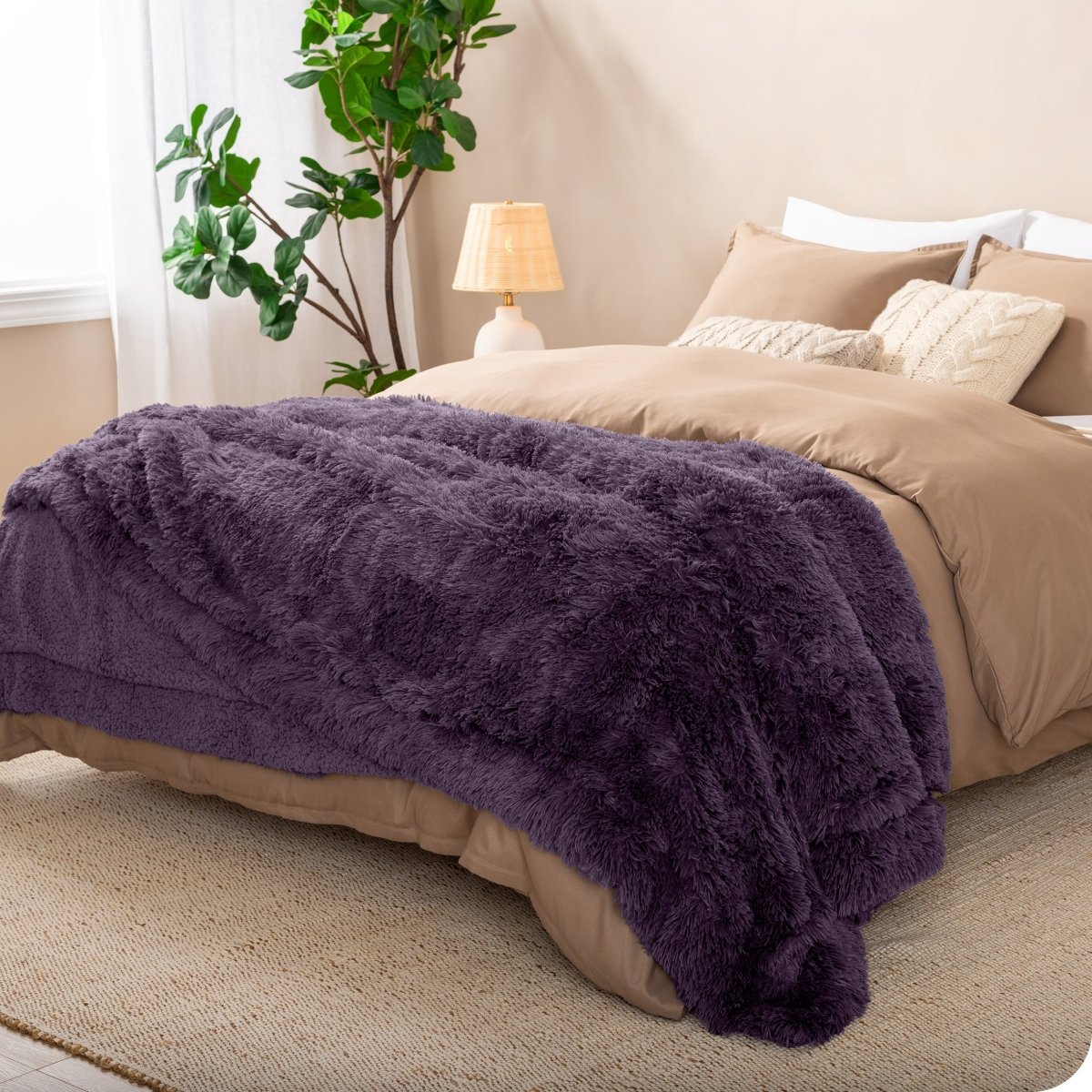 A shaggy faux fur blanket on the end of a bed