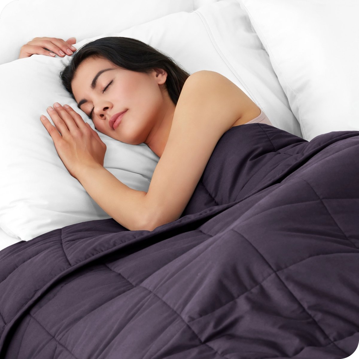 A woman sleeping with a weighted blanket over her body