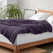A weighted blanket draped over a bed