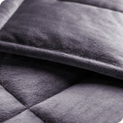 Close-up image of a weighted blanket, featuring detailed stitching and the neatly finished edge of the blanket.