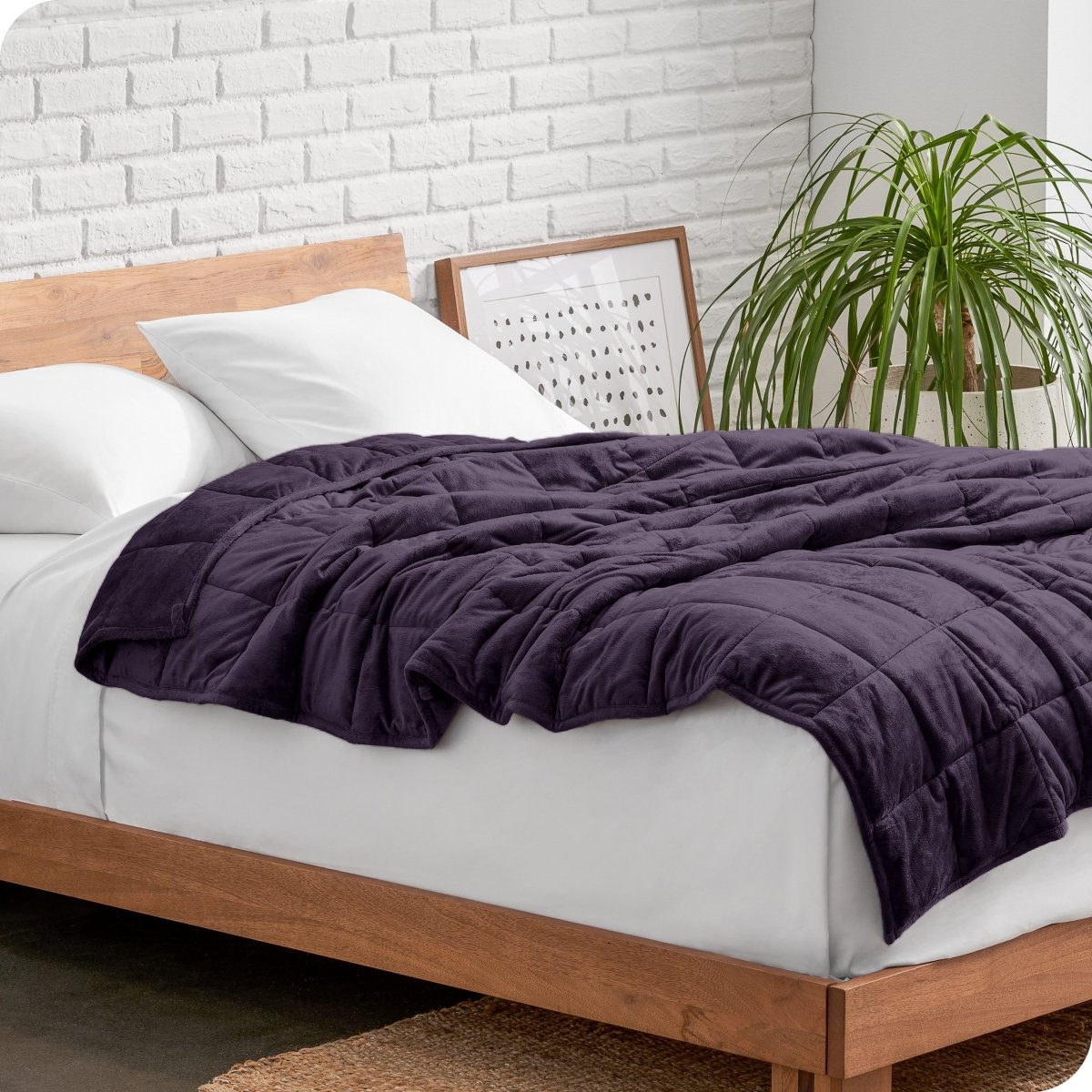 A weighted blanket draped over a bed