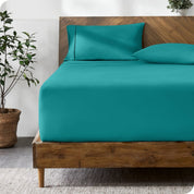 A bed with a fitted sheet and matching pillowcases