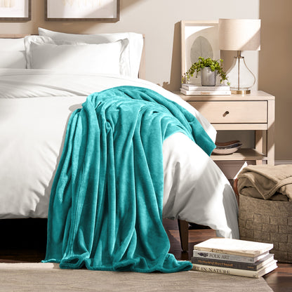 Microplush blanket draped over the corner of a bed