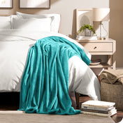 Microplush blanket draped over the corner of a bed