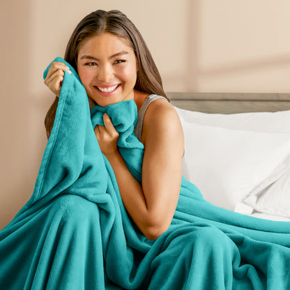 A woman cuddling with a microplush blanket