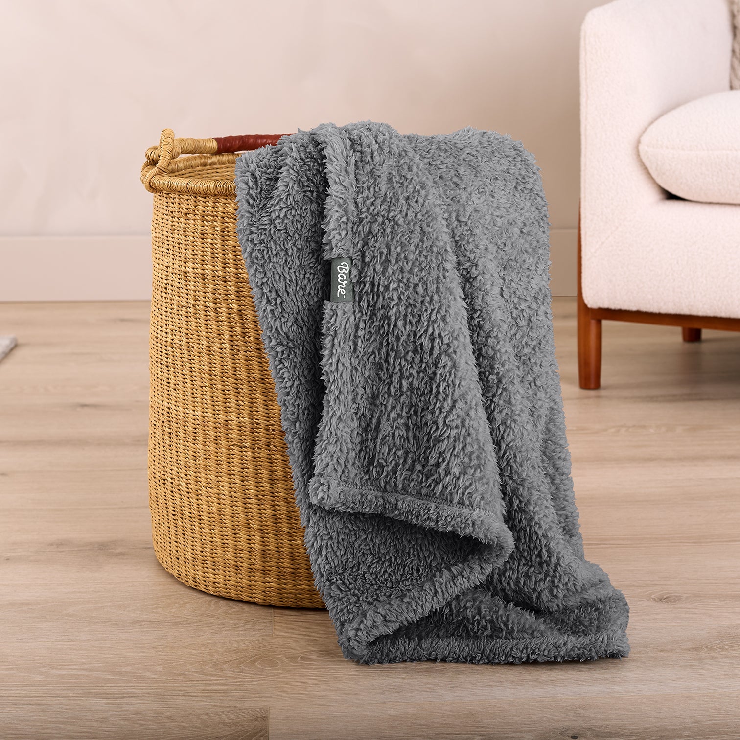 Grey Colored Sherpa Blanket Sitting in a clothes basket