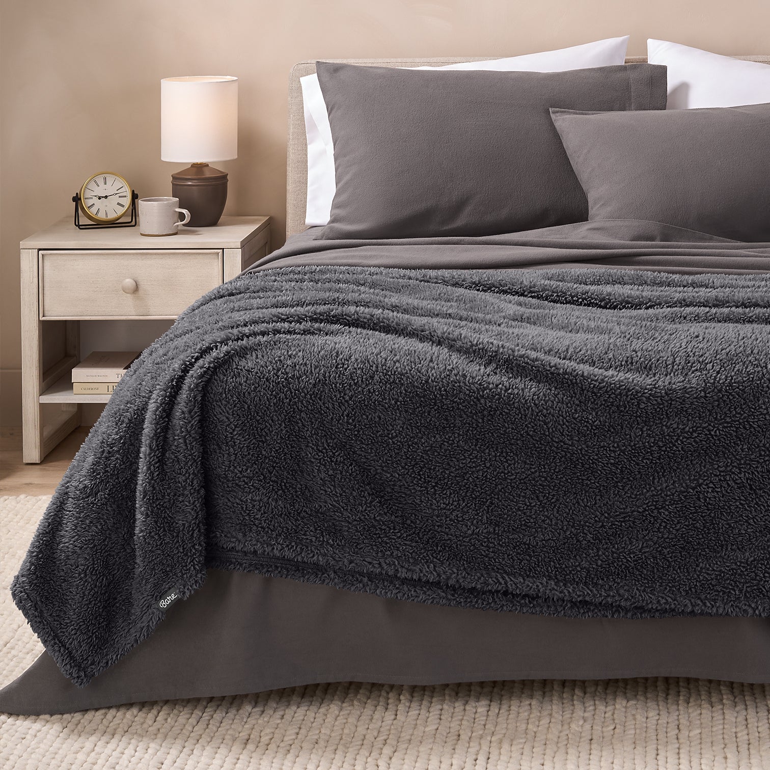 Forged Iron Grey Colored Sherpa Blanket on top of a made bed