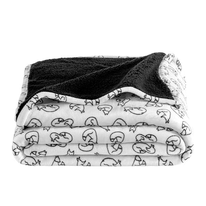 Folded blanket with black and white pattern on a white background
